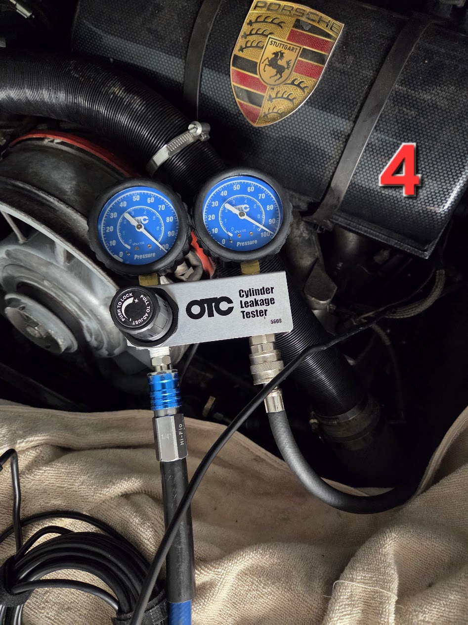 Cylinder leakage tester on Porsche engine cylinder four